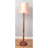 A mahogany standard lamp with reeded and turned column.