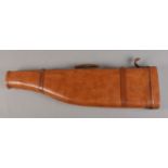 A brown leather shoulder of mutton gun case, with carry handle. 78cm long.