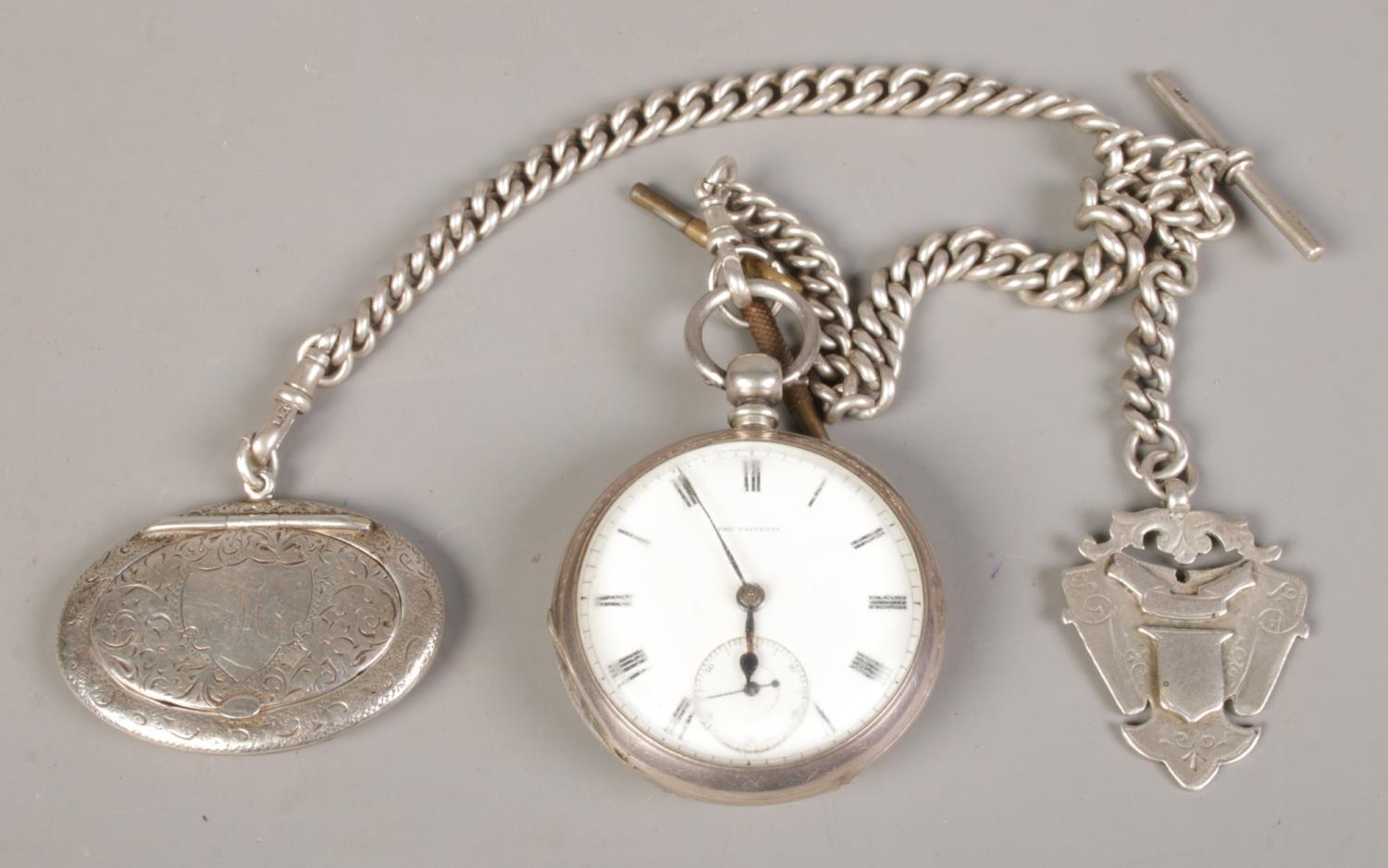 A silver cased pocket watch together with heavy silver chain, t-bar fob and hinged snuff box. Pocket