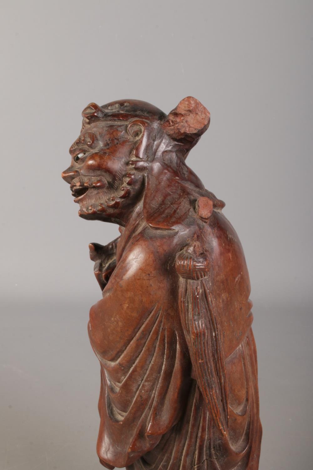 A Chinese carved hardwood figure. 39cm high. Damaged. One eye missing, piece missing from top, - Image 2 of 2