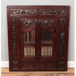 A large Indonesian carved hardwood hinged shutter door mirror. Height: 88cm, Width: 78cm.