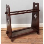 A stained oak arts and crafts three-section stick stand. Height: 66cm, Width: 68cm.