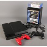 A Sony PlayStation 4 with two wireless dual shock controllers with chargers and quantity of games in