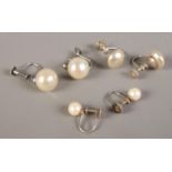 Three pairs of silver and pearl earrings.