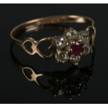 A 9ct gold cluster ring set with cubic zirconia and central red stone. Size O. 1.16g.