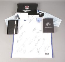 A 2017 England Football Team signed shirt, with certificate and matching Vauxhall notebook.