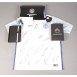 A 2017 England Football Team signed shirt, with certificate and matching Vauxhall notebook.