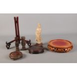 A collection of oriental items, to include carved stands, soapstone figure and hardstone specimen