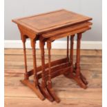 An Edwardian style nest of three walnut tables.