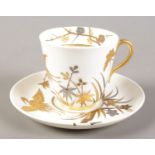 A 19th century Worcester cup and saucer decorated in gilt and silver in the Aesthetic style. Date