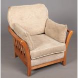 A large light oak armchair. With cream upholstery.