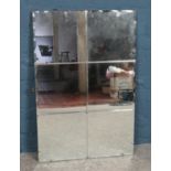 A vintage bevelled mirror. 92cm x 61cm.