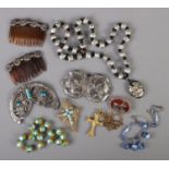 A tray of costume jewellery. Includes foil beads, buckles, crucifix pendants etc.