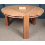 A circular oak designer dining table with care kit. (146cm diameter)
