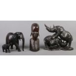 A collection of treen. To include ebonised elephants, rhino scene and tribal bust. Tusks have been