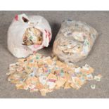 Two large bags containing a vast quantity of British postage stamps, including commemorative