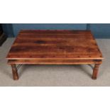 A hardwood coffee table with rivet design features. Dimensions 134cm x 91cm.