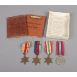 A set of four medals The Africa Star, The Italy Star, 1939-45 Star and 1939-45 War Medal alongside