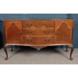A Queen Anne style walnut serpentine sideboard, with glass top, and carved edging and cabriole feet,