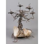 A decorative iron and quartz candle stand formed as a branching tree. 47cm.