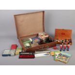 A leather suitcase containing an assortment of collectables. To include slide viewers, vintage