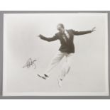 An autographed monochrome photograph of Fred Astaire.