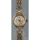 A ladies 14ct gold Dreffa manual wristwatch on gold plated bracelet strap. Does not wind. Not