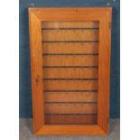 A wooden wall mounted key cabinet.