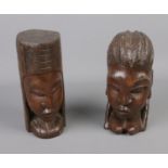 A pair of wooden carved tribal heads.