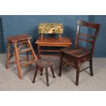 A collection of assorted furniture. Includes vintage chair with under seat storage, small stools,