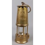 An Eccles Type 6 brass miners lamp by The Protector Lamp & Lighting Co Ltd.