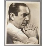 An autographed monochrome photograph of Bela Lugosi.
