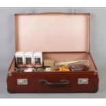 A leather suitcase containing an assortment of mainly boxed and loose diecast vehicles and