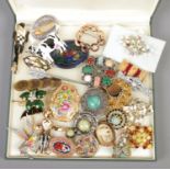 A case of costume jewellery brooches. Includes vintage and Deco examples.