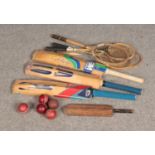 A quantity of sporting equipment including badminton rackets and baseball bats.