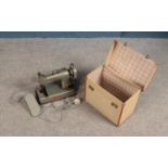 A silver Jones cylinder shuttle sewing machine with lockable case and key.