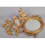 A quantity of gilt composite items. Including mirrors, cherubs, table lamp base, etc.