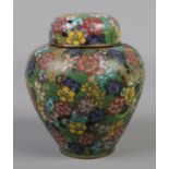 A small 19th century cloisonne lidded vase with floral decoration. 10.5cm. Slight dent to shoulder.