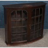 An oak bow front wall mounted display cabinet.