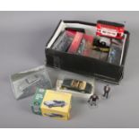 A box of diecast cars mainly consisting of various James Bond Aston Martins.