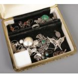 A jewellery case containing mainly silver jewellery. Includes pendants, earrings etc.