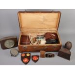 A case of collectables. Including bakelite smokers stand, badges, small binoculars, Yashica