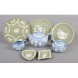 A collection of Wedgwood jasperware in green and blue. Includes teapot, sugar bowl and cream jug,