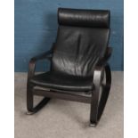 A black leather rocking chair with wooden frame.
