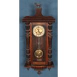 A carved mahogany 8 day wall clock. With horse finial.