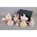 A collection of Dresden porcelain figurines featuring lacework dresses. One includes original box