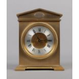 A small brass carriage clock with Roman numeral face.