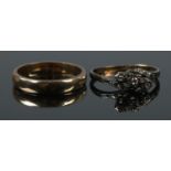 An 18ct gold and platinum three stone diamond ring (2.01g), along with a 9ct gold wedding band (2.