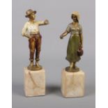 Two cold painted bronze figures with marble bases. One male and one female figure.