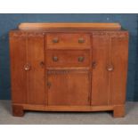 An oak sideboard with carved decoration.